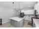 Modern kitchen with white cabinets, gray island, and gold fixtures at 37137 Florida Ave, Dade City, FL 33525