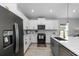 Modern kitchen with white shaker cabinets, quartz countertops, and stainless steel appliances at 37137 Florida Ave, Dade City, FL 33525