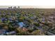 Aerial view of a house nestled in a quiet neighborhood, with a city skyline visible in the background at 400 22Nd Ne Ave, St Petersburg, FL 33704