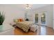 Bedroom with floral bedding, hardwood floors, and access to a private patio at 400 22Nd Ne Ave, St Petersburg, FL 33704