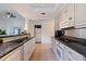 Modern kitchen with granite countertops, white cabinets, and stainless steel appliances at 400 22Nd Ne Ave, St Petersburg, FL 33704