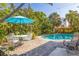 Inviting pool area with patio furniture and umbrella at 400 22Nd Ne Ave, St Petersburg, FL 33704