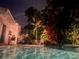 Relaxing nighttime view of a private pool and lush tropical landscaping at 400 22Nd Ne Ave, St Petersburg, FL 33704