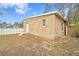 Tan block studio with white door, window, and small steps at 4008 W North B St, Tampa, FL 33609