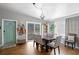 Bright dining area with a wooden table, view into living room and entryway at 4008 W North B St, Tampa, FL 33609