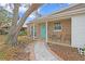 Inviting front exterior with teal door, walkway, and small patio set at 4008 W North B St, Tampa, FL 33609