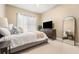 Bedroom with a queen bed, dresser, and large mirror at 418 S Albany Ave, Tampa, FL 33606