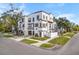 Three-story home with stucco exterior, two-car garage, and a landscaped yard at 418 S Albany Ave, Tampa, FL 33606