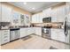 Modern kitchen with white cabinets, stainless steel appliances, and granite countertops at 418 S Albany Ave, Tampa, FL 33606