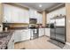 Modern kitchen with stainless steel appliances, granite countertops, and white cabinets at 418 S Albany Ave, Tampa, FL 33606