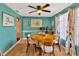 Dining area with round table, four chairs, and teal walls at 4308 Craftsbury Dr, New Port Richey, FL 34652