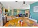 Dining area with a round table and chairs, teal walls, and hardwood floors at 4308 Craftsbury Dr, New Port Richey, FL 34652