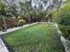 Landscaped backyard with lush green lawn and tropical plants at 4529 11Th S Ave, St Petersburg, FL 33711