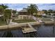 Waterfront property showcasing a home, dock, and surrounding neighborhood at 4536 Heavens Way, New Port Richey, FL 34652