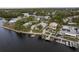 Aerial view of a waterfront home with a pool and dock at 4536 Heavens Way, New Port Richey, FL 34652