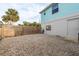 Gravel backyard with wooden fence and exterior wall at 4536 Heavens Way, New Port Richey, FL 34652