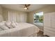 Bedroom with white bedding, wood floors, and water views at 4536 Heavens Way, New Port Richey, FL 34652