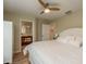 Main bedroom with white bedding and en-suite bathroom at 4536 Heavens Way, New Port Richey, FL 34652