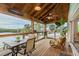 Relaxing screened porch with water views and wooden furniture at 4536 Heavens Way, New Port Richey, FL 34652