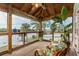 Waterfront screened porch with comfy seating and plants at 4536 Heavens Way, New Port Richey, FL 34652