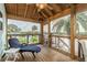 Relaxing screened porch with wooden floors, seating and water views at 4536 Heavens Way, New Port Richey, FL 34652