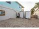 Gravel-covered side yard with storage containers and exterior wall at 4536 Heavens Way, New Port Richey, FL 34652