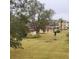 View of backyard with green grass and trees at 4920 Locust Ne St # 203, St Petersburg, FL 33703