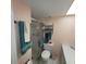 Clean bathroom with shower and tub, shelving and linen closet at 4920 Locust Ne St # 203, St Petersburg, FL 33703