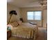 Main bedroom with floral bedding and a large window at 4920 Locust Ne St # 203, St Petersburg, FL 33703