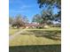 Well-maintained lawn and common green space with mature trees and community buildings at 4920 Locust Ne St # 203, St Petersburg, FL 33703