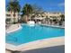 Community swimming pool with lounge chairs and palm trees at 4920 Locust Ne St # 203, St Petersburg, FL 33703