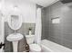 Modern bathroom with gray tile and updated fixtures at 5118 Murray Hill Dr, Tampa, FL 33615