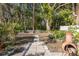 Landscaped backyard with a pathway and garden at 6 Freshwater Dr, Palm Harbor, FL 34684