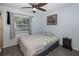 Guest bedroom with a full-size bed and a window at 6 Freshwater Dr, Palm Harbor, FL 34684