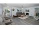 Spacious living room featuring a fireplace and grey sofas at 6 Freshwater Dr, Palm Harbor, FL 34684