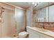 Bathroom featuring a glass-enclosed shower and a floral-patterned wallpaper at 6158 Palma Del Mar S Blvd # 116, St Petersburg, FL 33715