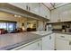 Kitchen with white cabinets, a grey countertop and pass-through to the living room at 6158 Palma Del Mar S Blvd # 116, St Petersburg, FL 33715