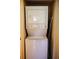 Convenient stacked washer and dryer in closet with ironing board and door at 6158 Palma Del Mar S Blvd # 116, St Petersburg, FL 33715