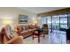 Comfortable living room with couch and view to the lanai at 6158 Palma Del Mar S Blvd # 116, St Petersburg, FL 33715