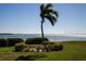 Scenic waterfront view with palm trees and lush landscaping at 6158 Palma Del Mar S Blvd # 116, St Petersburg, FL 33715