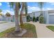 Front view of townhome with palm trees and walkway at 6320 Grand Bahama Cir # 6320, Tampa, FL 33615