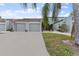 Townhouse exterior with double garage and American flag at 6320 Grand Bahama Cir # 6320, Tampa, FL 33615