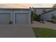 Townhouse exterior featuring attached garage and landscaped walkway at 6320 Grand Bahama Cir # 6320, Tampa, FL 33615