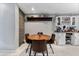 Dining area with round wooden table and brown leather chairs at 6405 Julie St, Tampa, FL 33610