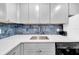 Modern kitchen with gray cabinets, quartz countertops, and stainless steel appliances at 6960 20Th N Ave # 307, St Petersburg, FL 33710