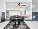 Modern kitchen with black stovetop and view into living room at 6960 20Th N Ave # 307, St Petersburg, FL 33710