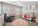 Charming Bedroom with crib and comfortable seating at 7878 Greenway Ave, Wesley Chapel, FL 33544