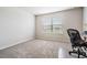 Bright bedroom with carpeted floor and home office setup at 7878 Greenway Ave, Wesley Chapel, FL 33544