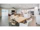 Open concept dining area with wooden table and view of kitchen and living room at 7878 Greenway Ave, Wesley Chapel, FL 33544