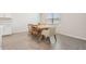 Dining area with wooden table and light-colored chairs at 7878 Greenway Ave, Wesley Chapel, FL 33544